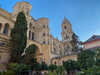 Low angle view of historic málaga cathedral against clear sky