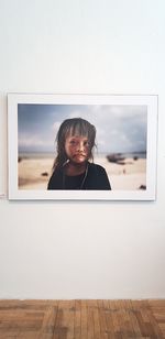 Portrait of woman against window on wall