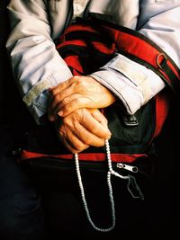 Midsection of man holding hands