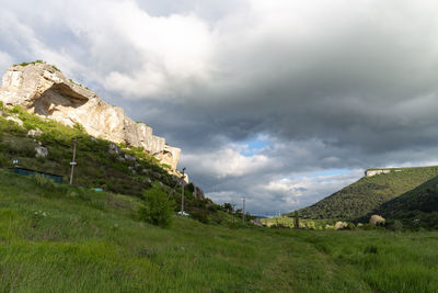 Built structure on landscape against sky
