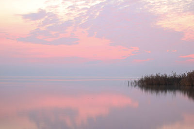 Scenic view of lake against sky during sunset