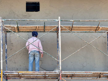 Rear view of man working at construction site