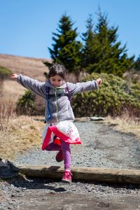 Full length of woman with arms raised