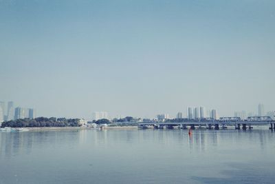 City by sea against clear sky
