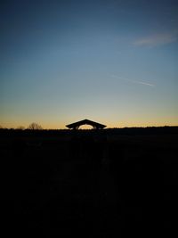 Scenic view of silhouette field against sky during sunset