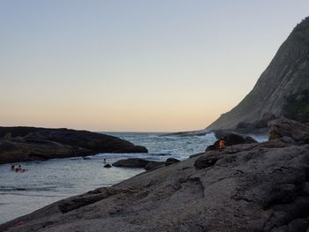 People at beach during sunset