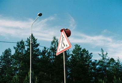 Low angle view of road sign against sky