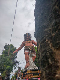 Low angle view of statue against sky