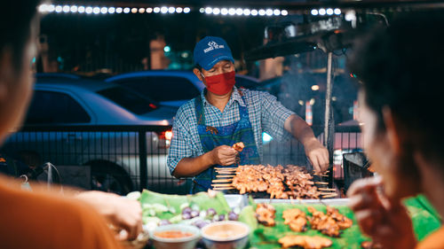 Group of people in restaurant at market