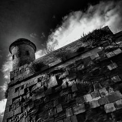 Low angle view of building against cloudy sky