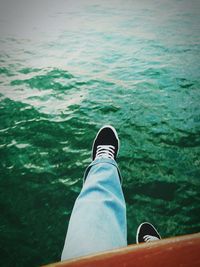 Low section of woman standing in water