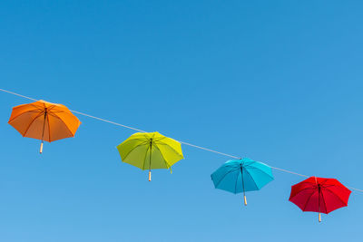 Low angle view of kite against clear blue sky