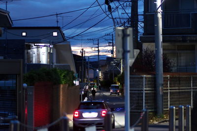 Cars on road amidst buildings in city