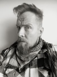 Portrait of bearded man against wall