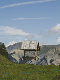 Built structure on field against sky