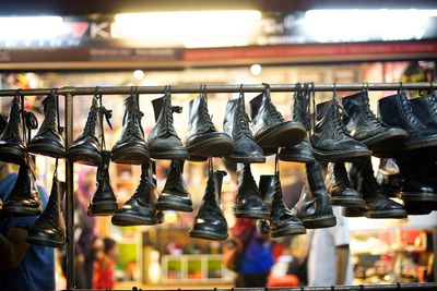 Shoes hanging on rack at market