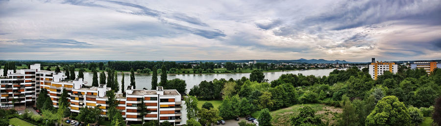 High angle view of buildings and trees against sky