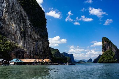 Scenic view of rock formation by sea against sky