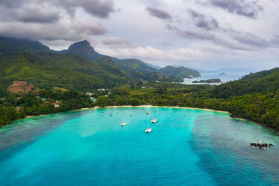 Scenic view of sea and mountains against sky