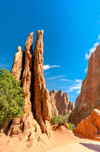 Low angle view of rock formation against blue sky