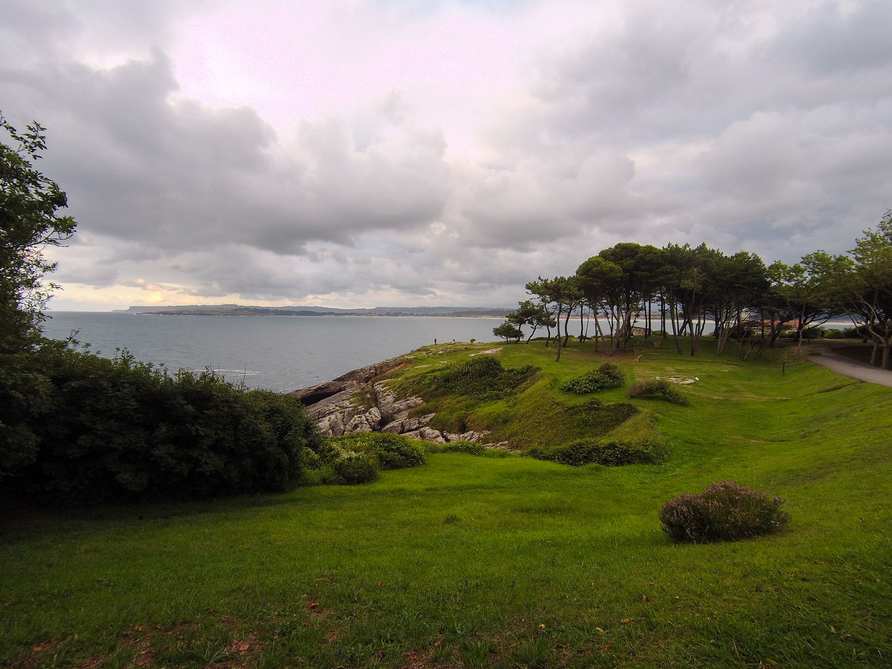 plant, sky, cloud, nature, water, grass, hill, environment, land, tree, landscape, sea, rural area, beauty in nature, scenics - nature, coast, travel destinations, architecture, no people, travel, tranquility, beach, green, tourism, outdoors, horizon, coastline, holiday, tranquil scene, building, trip, vacation, built structure, overcast, meadow, shore, day, non-urban scene, summer, field