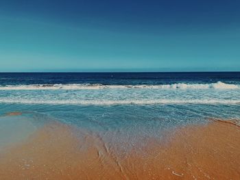 Scenic view of sea against clear blue sky