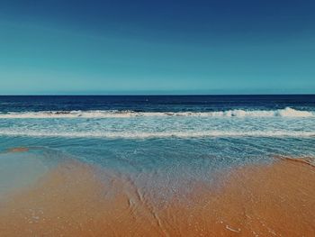 Scenic view of sea against clear blue sky
