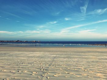 Scenic view of beach against blue sky