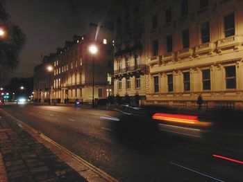 Cars on city street at night