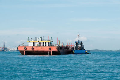 Ship sailing on sea against sky