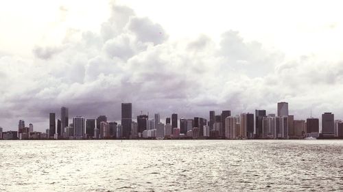 Panoramic view of sea and buildings against sky