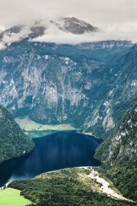 High angle view of lake amidst mountains against sky