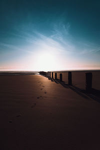 Scenic view of beach against sky during sunrise