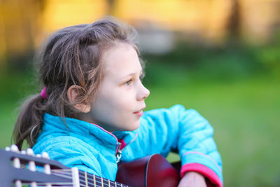 Portrait of cute girl looking away outdoors