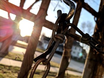 Close-up of rusty chain hanging on fence