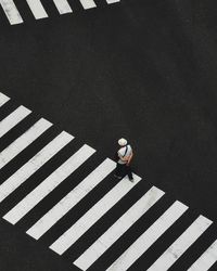 High angle view of person crossing road