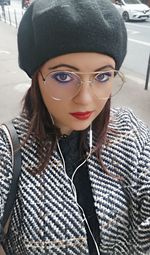 Portrait of young woman wearing hat