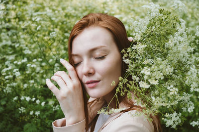 Portrait of beautiful young woman with eyes closed