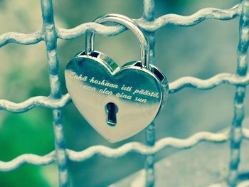 Close-up of padlocks hanging on metal