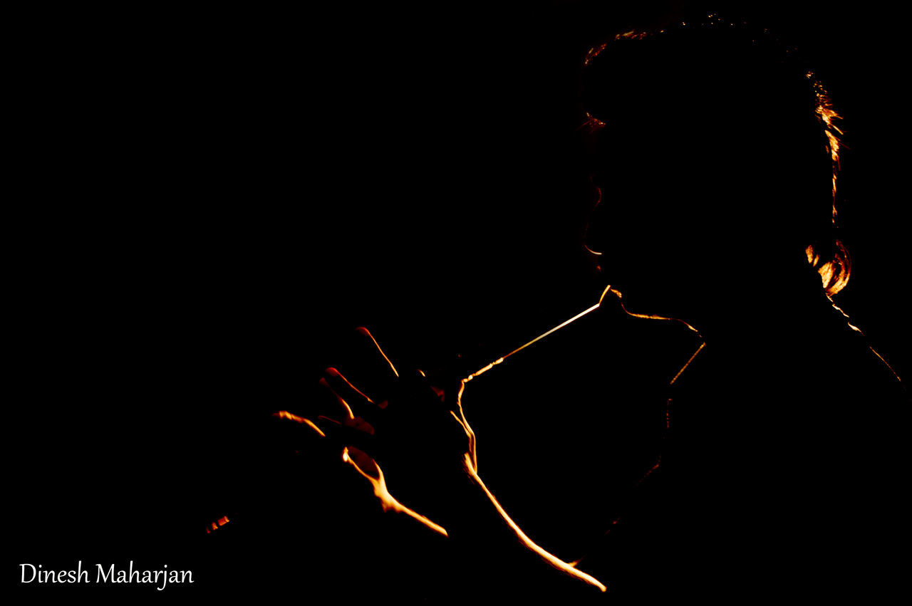 CLOSE-UP OF SILHOUETTE MAN AGAINST BLACK BACKGROUND AT NIGHT