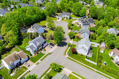 High angle view of road amidst trees and buildings