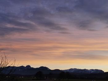 Scenic view of silhouette mountains against sky during sunset