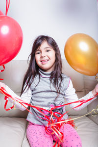Portrait of a smiling girl with balloons