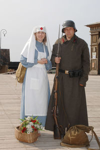 Portrait of people wearing old-fashioned costumes standing outdoors