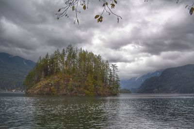 Scenic view of lake by trees against sky