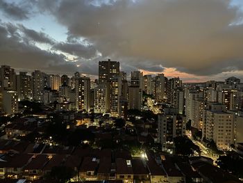 High angle view of illuminated buildings against sky in city