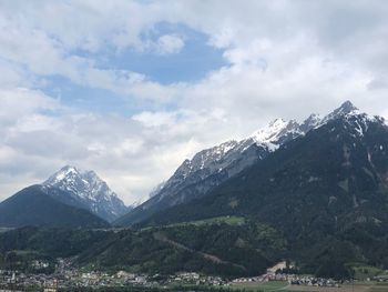 Scenic view of mountains against cloudy sky