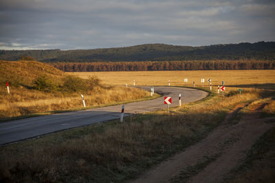 Road by mountain against sky