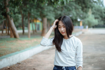 Smiling young woman standing outdoors