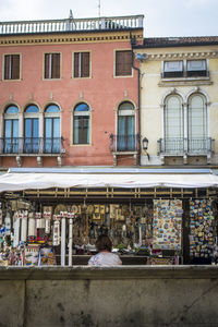 Woman on street by building in city